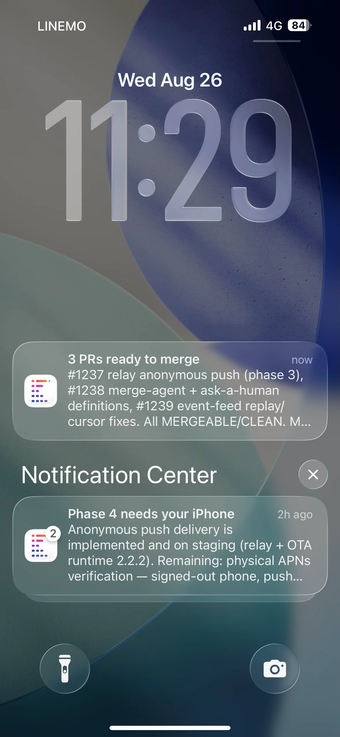 iPhone lock screen showing Kanna notifications for merge-ready pull requests and a task needing attention